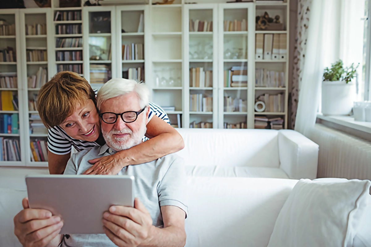 Image of a cuple using Patient Access on there tablet at home